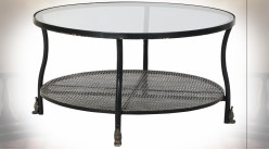 Table basse en métal finition noire et reflets dorés, plateau en verre transparent ambiance industrielle, Ø85cm