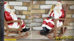 Statuette en résine Père-Noël dans son fauteuil à bascule en bois 55 cm